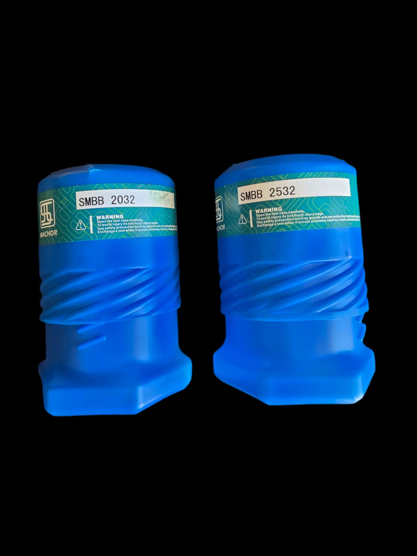 Two blue plastic containers with green labels on a black surface