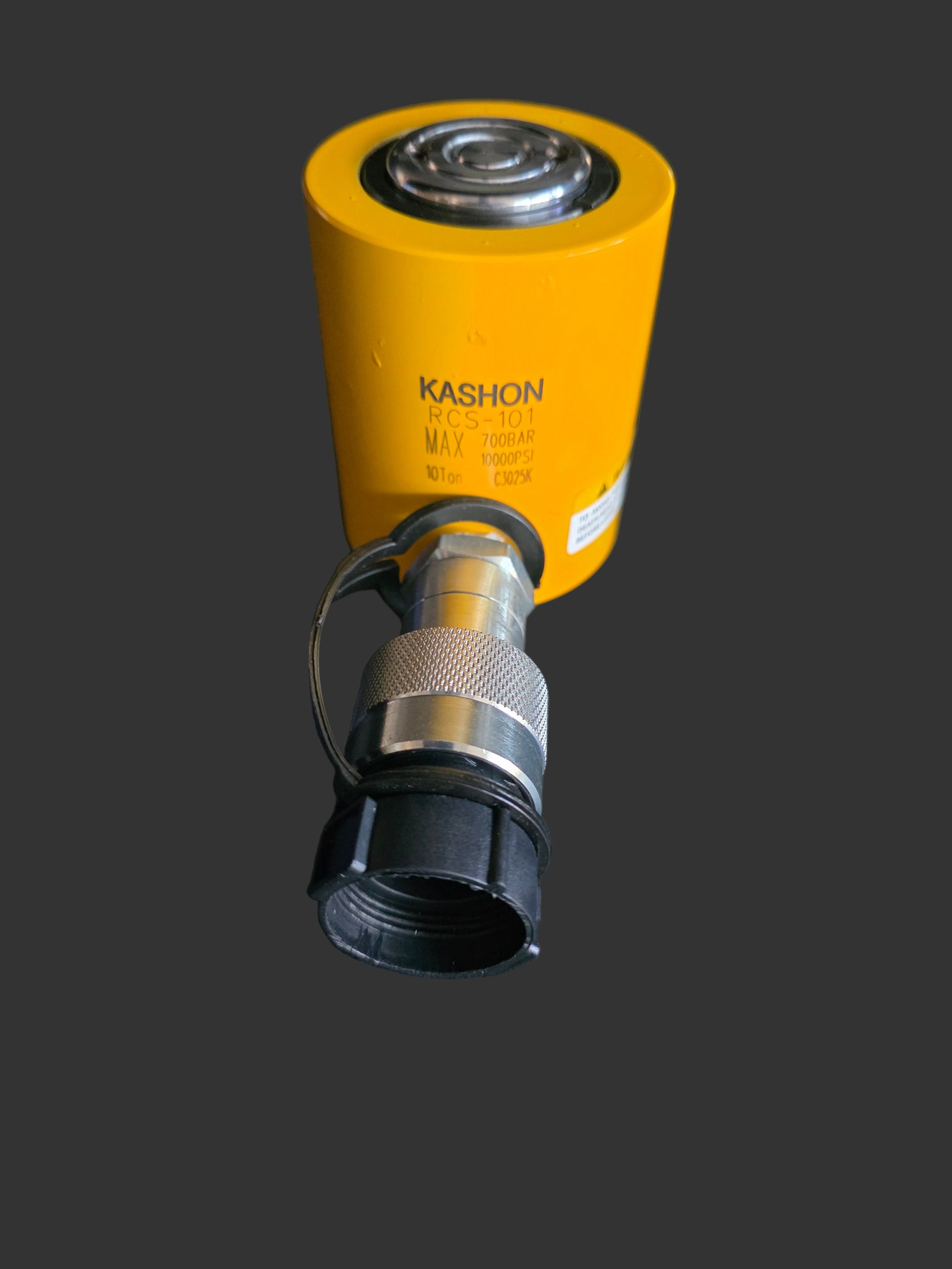Yellow cylindrical tool with metallic components on a black background